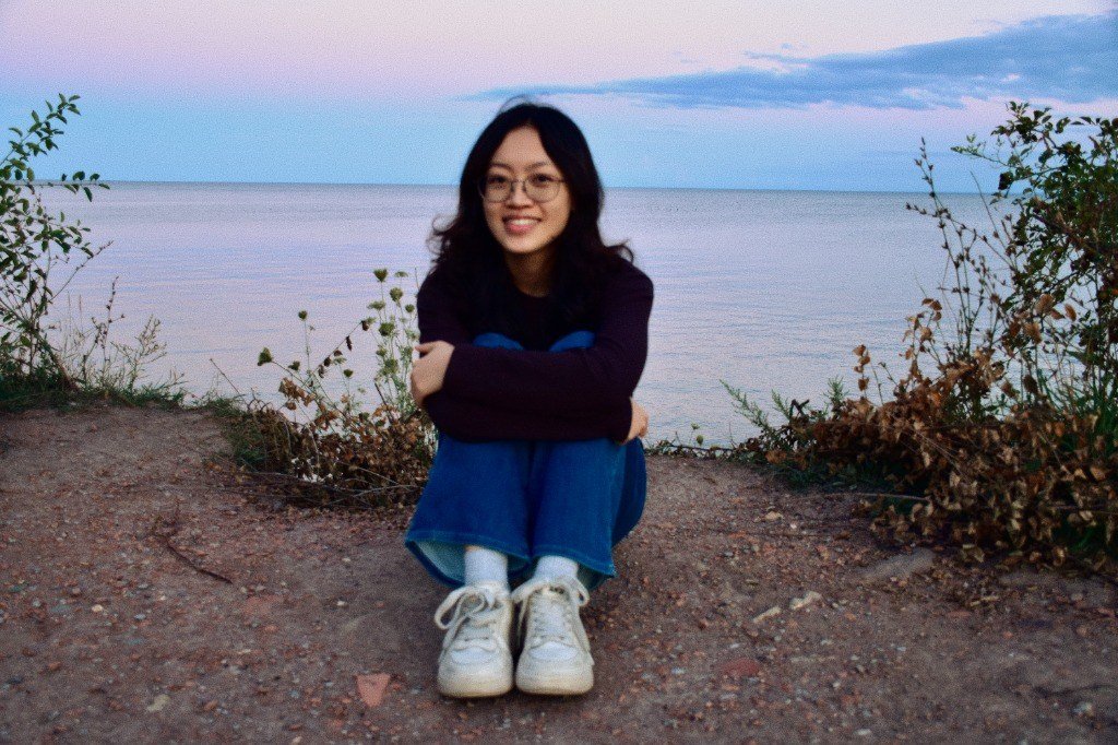 Emma Luo sitting by the water